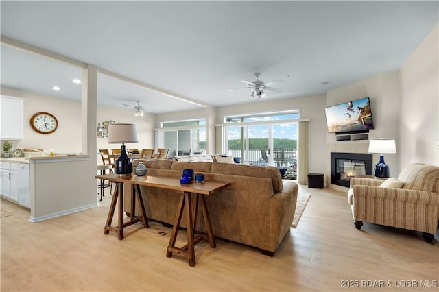 5450 Christopher Ln Unit 211, Osage Beach, MO 65065 - living area with a ceiling fan, light wood-style flooring, recessed lighting, and a glass covered fireplace