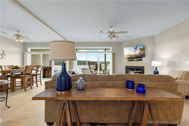 5450 Christopher Ln Unit 211, Osage Beach, MO 65065 - living room featuring a ceiling fan, a tile fireplace, and light wood-type flooring