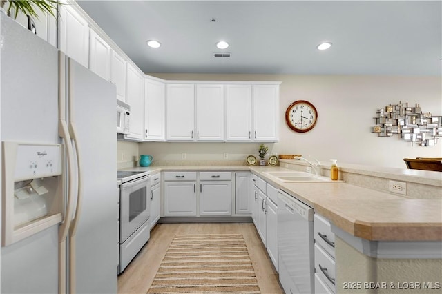 5450 Christopher Ln Unit 211, Osage Beach, MO 65065 - kitchen featuring white appliances, a peninsula, white cabinetry, and recessed lighting