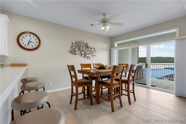 5450 Christopher Ln Unit 211, Osage Beach, MO 65065 - dining area with light wood-style floors and ceiling fan