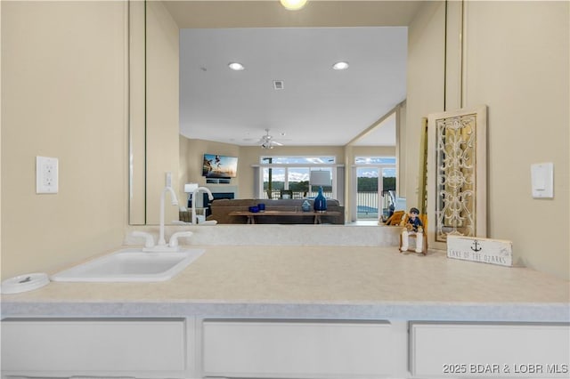 5450 Christopher Ln Unit 211, Osage Beach, MO 65065 - kitchen with white cabinetry, light countertops, recessed lighting, ceiling fan, and open floor plan