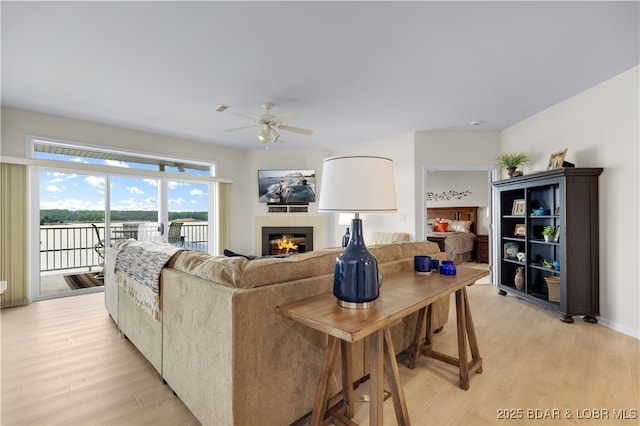 5450 Christopher Ln Unit 211, Osage Beach, MO 65065 - living room with ceiling fan, light wood-style floors, and a fireplace