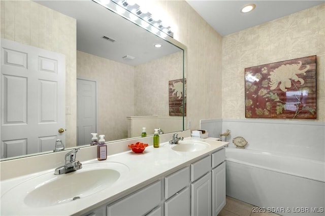 5450 Christopher Ln Unit 211, Osage Beach, MO 65065 - bathroom featuring double vanity, a garden tub, wallpapered walls, and recessed lighting