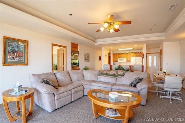 49 Aqua Fin Dr Unit 3B, Lake Ozark, MO 65049 - living area featuring light colored carpet, a ceiling fan, a raised ceiling, and recessed lighting