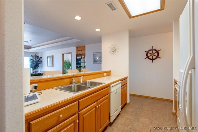 49 Aqua Fin Dr Unit 3B, Lake Ozark, MO 65049 - kitchen featuring white appliances, light countertops, light tile patterned floors, recessed lighting, and brown cabinets