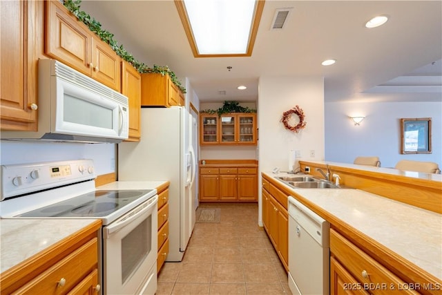49 Aqua Fin Dr Unit 3B, Lake Ozark, MO 65049 - kitchen with white appliances, light tile patterned floors, light countertops, recessed lighting, and brown cabinets