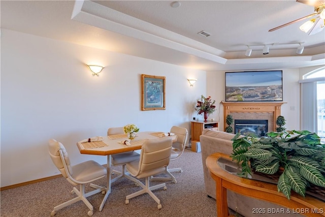 49 Aqua Fin Dr Unit 3B, Lake Ozark, MO 65049 - carpeted dining space featuring a ceiling fan and a glass covered fireplace