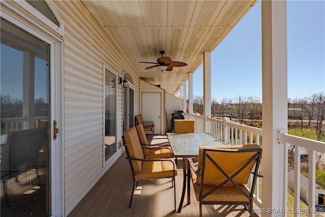 49 Aqua Fin Dr Unit 3B, Lake Ozark, MO 65049 - view of wooden balcony with a ceiling fan, outdoor dining space, and a wooden deck