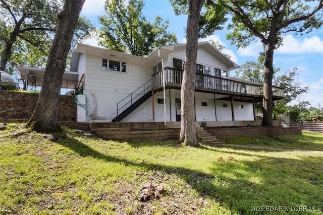 43 Bob White Ln, Lake Ozark, MO 65049 - rear view of house featuring stairs, a deck, and a lawn
