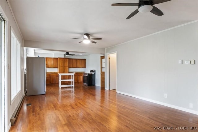 43 Bob White Ln, Lake Ozark, MO 65049 - unfurnished living room with a ceiling fan, wood finished floors, and ornamental molding