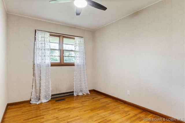 43 Bob White Ln, Lake Ozark, MO 65049 - unfurnished room featuring wood finished floors, a ceiling fan, ornamental molding, and baseboard heating