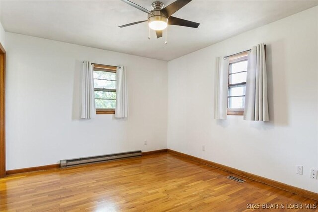 43 Bob White Ln, Lake Ozark, MO 65049 - empty room with a baseboard heating unit, light wood-style floors, and ceiling fan