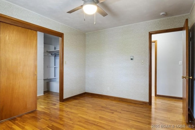 43 Bob White Ln, Lake Ozark, MO 65049 - unfurnished bedroom featuring crown molding, light wood finished floors, a closet, ceiling fan, and a spacious closet