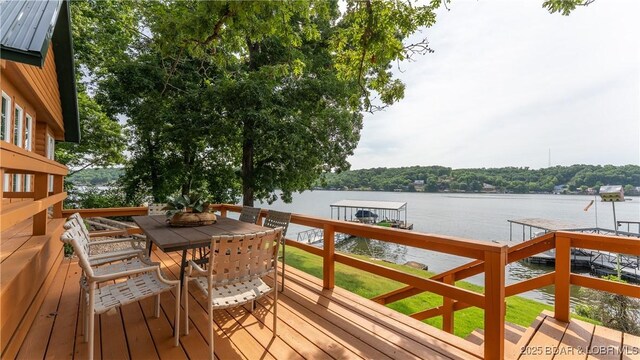15350 Red Hollow Rd, Gravois Mills, MO 65037 - wooden deck featuring a water view, a boat dock, boat lift, and outdoor dining space