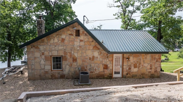 15350 Red Hollow Rd, Gravois Mills, MO 65037 - view of home's exterior with stone siding, a chimney, and a metal roof