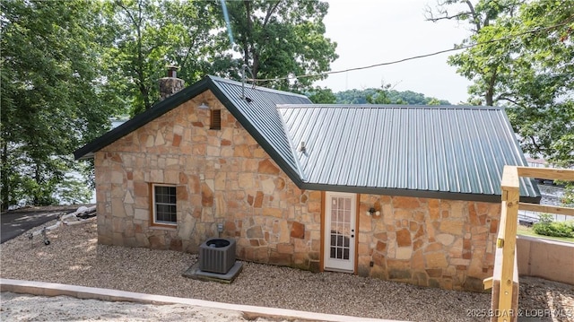 15350 Red Hollow Rd, Gravois Mills, MO 65037 - rear view of house with stone siding, a chimney, and a metal roof