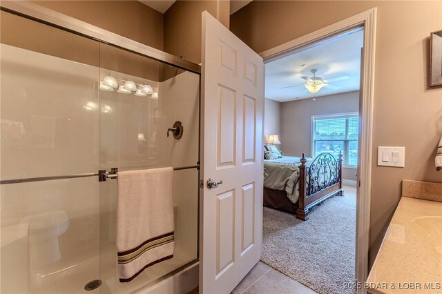 730 Flame Dr Unit 3C, Camdenton, MO 65020 - full bath featuring a stall shower, a ceiling fan, vanity, tile patterned floors, and ensuite bathroom