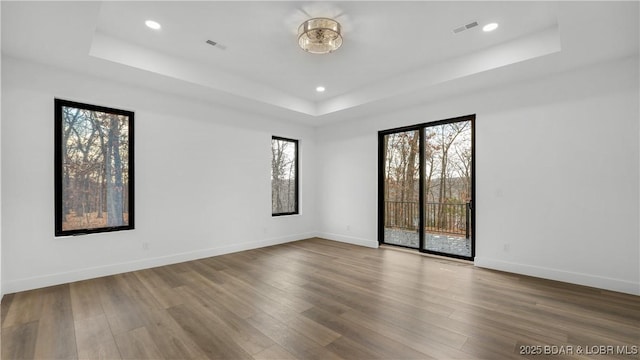 971 Grand Point Blvd, Porto Cima, MO 65079 - unfurnished room featuring a tray ceiling, wood finished floors, and recessed lighting