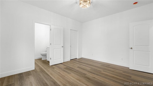 971 Grand Point Blvd, Porto Cima, MO 65079 - unfurnished bedroom with wood finished floors and connected bathroom