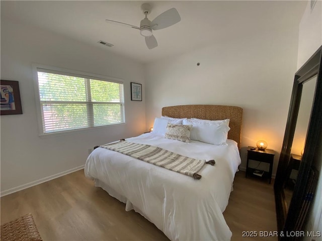 42 Palisades Lakeview Dr Unit 4B, Lake Ozark, MO 65049 - bedroom with wood finished floors and ceiling fan
