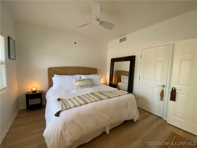 42 Palisades Lakeview Dr Unit 4B, Lake Ozark, MO 65049 - bedroom featuring wood finished floors and a ceiling fan