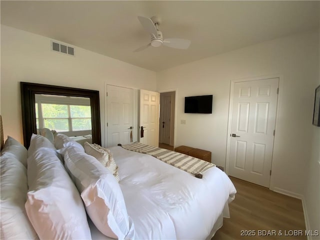 42 Palisades Lakeview Dr Unit 4B, Lake Ozark, MO 65049 - bedroom featuring wood finished floors and a ceiling fan