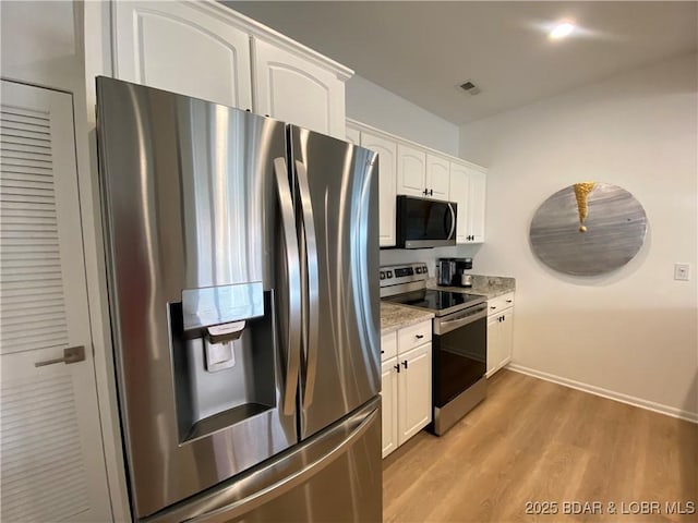 42 Palisades Lakeview Dr Unit 4B, Lake Ozark, MO 65049 - kitchen featuring appliances with stainless steel finishes, white cabinetry, light wood-style flooring, and light stone counters