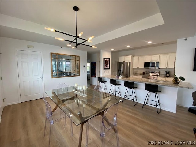 42 Palisades Lakeview Dr Unit 4B, Lake Ozark, MO 65049 - dining space with light wood-style flooring, a chandelier, and recessed lighting