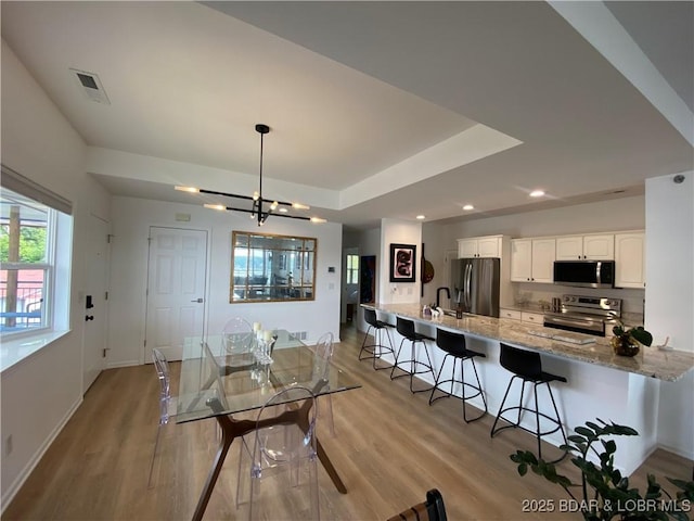 42 Palisades Lakeview Dr Unit 4B, Lake Ozark, MO 65049 - dining area with light wood finished floors, a chandelier, and recessed lighting