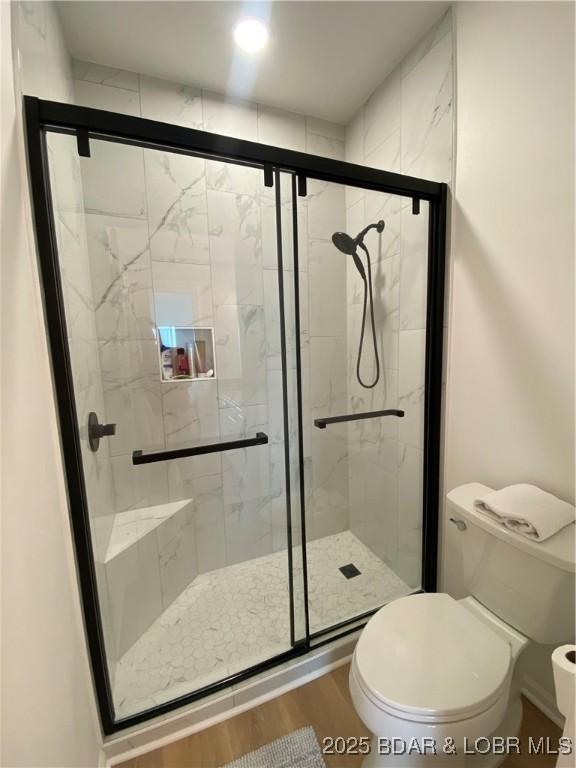 42 Palisades Lakeview Dr Unit 4B, Lake Ozark, MO 65049 - bathroom featuring wood finished floors and a stall shower