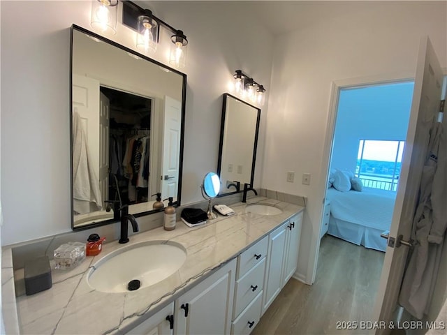 42 Palisades Lakeview Dr Unit 4B, Lake Ozark, MO 65049 - bathroom featuring ensuite bathroom, double vanity, wood finished floors, and a spacious closet