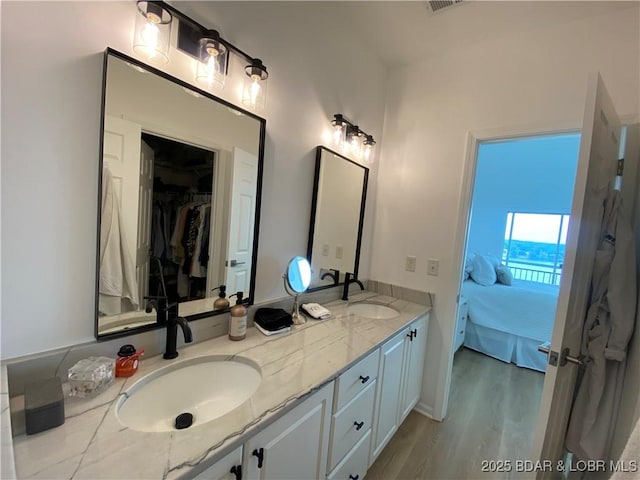 42 Palisades Lakeview Dr Unit 4B, Lake Ozark, MO 65049 - full bath featuring connected bathroom, double vanity, wood finished floors, and a walk in closet