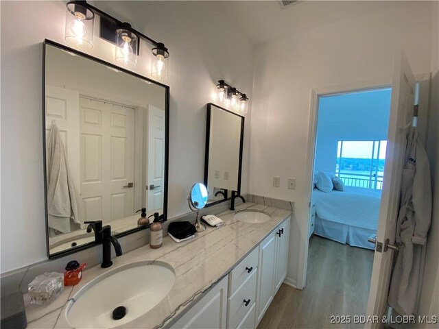 42 Palisades Lakeview Dr Unit 4B, Lake Ozark, MO 65049 - ensuite bathroom with double vanity and wood finished floors