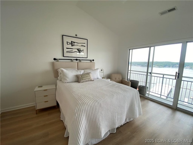 42 Palisades Lakeview Dr Unit 4B, Lake Ozark, MO 65049 - bedroom featuring access to outside, wood finished floors, multiple windows, a water view, and high vaulted ceiling