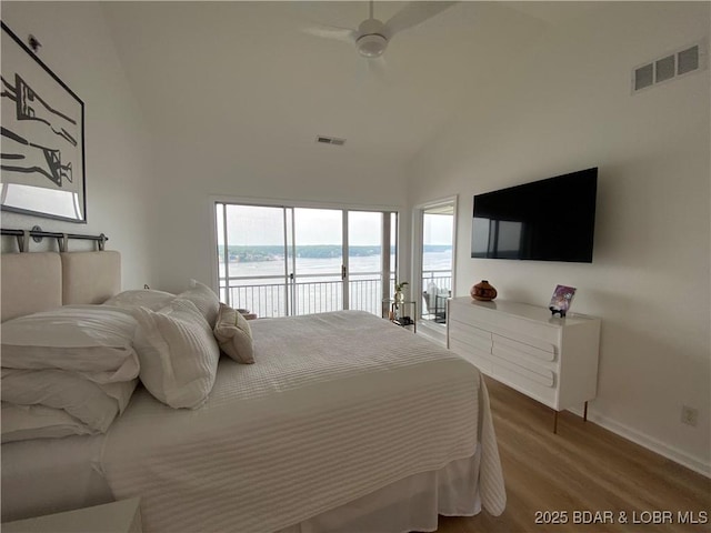 42 Palisades Lakeview Dr Unit 4B, Lake Ozark, MO 65049 - bedroom featuring access to outside, wood finished floors, and high vaulted ceiling