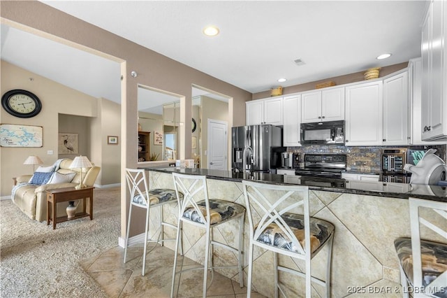 6680 Keystone Dr Unit 241, Osage Beach, MO 65065 - kitchen featuring black appliances, white cabinets, recessed lighting, decorative backsplash, and light carpet