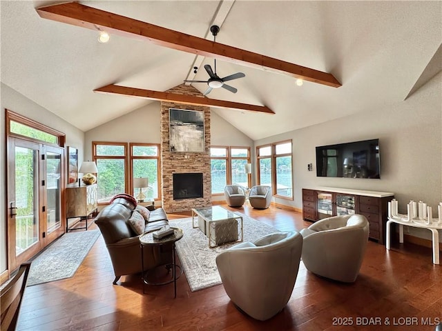 158 Oak Manor Cir, Sunrise Beach, MO 65079 - living room with beam ceiling, wood-type flooring, plenty of natural light, a ceiling fan, and high vaulted ceiling