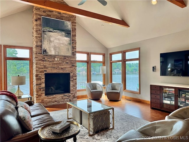 158 Oak Manor Cir, Sunrise Beach, MO 65079 - living room featuring high vaulted ceiling, wood finished floors, beam ceiling, plenty of natural light, and a ceiling fan