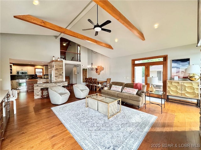 158 Oak Manor Cir, Sunrise Beach, MO 65079 - living area with beamed ceiling, a ceiling fan, light wood-type flooring, and high vaulted ceiling
