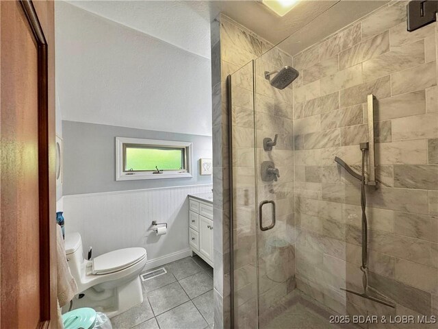 158 Oak Manor Cir, Sunrise Beach, MO 65079 - full bath with a shower stall, tile patterned floors, a wainscoted wall, and vanity