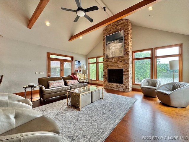 158 Oak Manor Cir, Sunrise Beach, MO 65079 - living area with beam ceiling, hardwood / wood-style floors, ceiling fan, high vaulted ceiling, and a stone fireplace