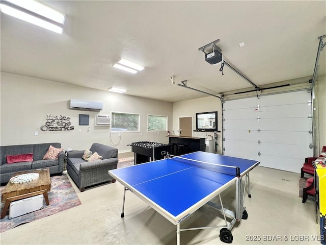 158 Oak Manor Cir, Sunrise Beach, MO 65079 - rec room with concrete floors, a wall unit AC, and a garage