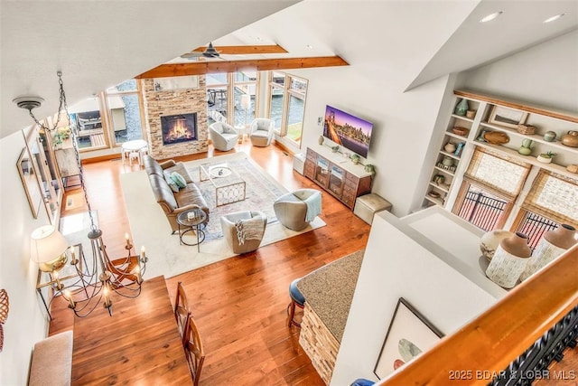 158 Oak Manor Cir, Sunrise Beach, MO 65079 - living room with wood finished floors, a fireplace, and lofted ceiling