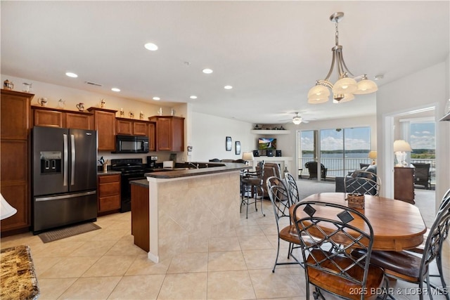 18136 Millstone Cove Rd Unit 136, Gravois Mills, MO 65037 - kitchen featuring black appliances, dark countertops, a ceiling fan, recessed lighting, and light tile patterned flooring