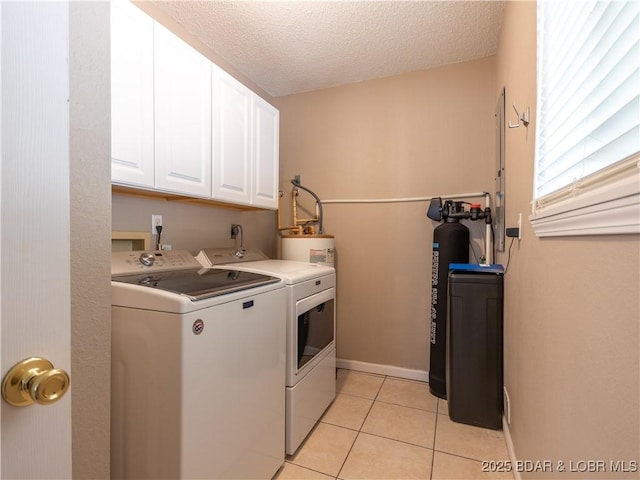 1403 Ginger Rd, Lake Ozark, MO 65049 - laundry room with washer and dryer, cabinet space, light tile patterned floors, and a textured ceiling