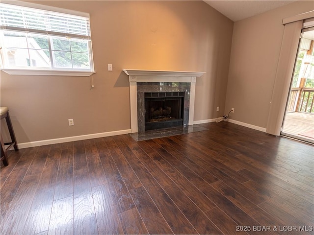 1403 Ginger Rd, Lake Ozark, MO 65049 - unfurnished living room with a high end fireplace, wood-type flooring, and healthy amount of natural light