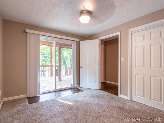 1403 Ginger Rd, Lake Ozark, MO 65049 - unfurnished bedroom featuring access to exterior, carpet flooring, a textured ceiling, and ceiling fan