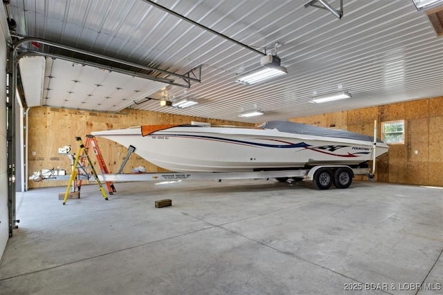 33682 Daybreak Rd, Gravois Mills, MO 65037 - garage with wooden walls and a garage door opener