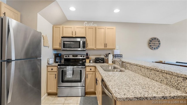 133 Cedar Glen Ct Unit 4B, Camdenton, MO 65020 - kitchen with appliances with stainless steel finishes, light brown cabinets, a peninsula, light stone counters, and vaulted ceiling