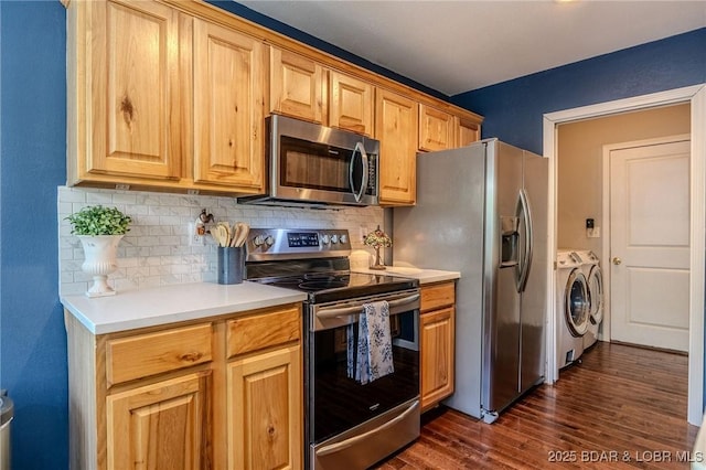 1170 San Jose Dr, Osage Beach, MO 65065 - kitchen with appliances with stainless steel finishes, washer and clothes dryer, backsplash, dark wood-type flooring, and light countertops